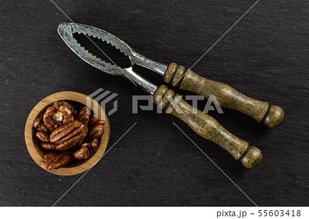 Fresh pecan nut on grey stone Fresh pecan nut on grey stone 55603418