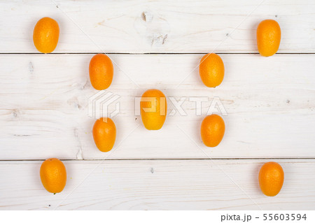 Fresh orange kumquat on grey wood 55603594
