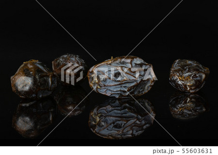 Dried date medjool isolated on black glass 55603631