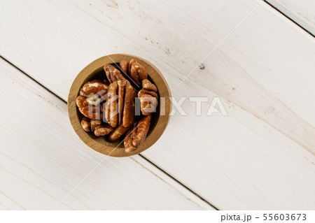 Fresh pecan nut on grey wood Fresh pecan nut on grey wood 55603673