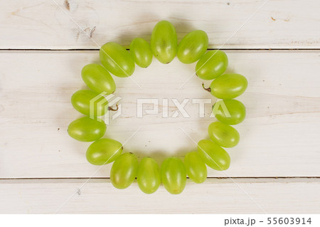 Fresh green grape on grey wood Fresh green grape on grey wood 55603914
