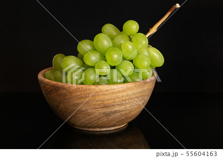 Fresh green grape isolated on black glass Fresh green grape isolated on black glass 55604163