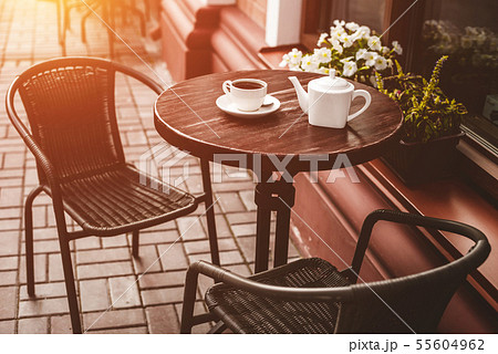 Street view of a empty terrace cafe. 55604962