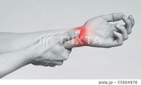 Man massaging painful wrist, monochrome panorama photo 55604976