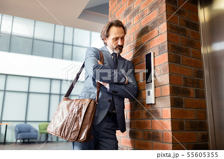 Bearded businessman hating waiting near the elevator 55605355