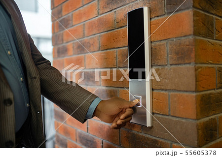 Young businessman wearing striped jacket pressing button 55605378