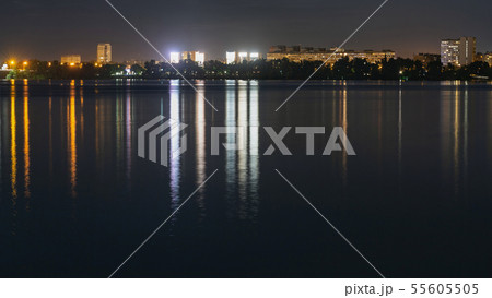 Skyline panorama of night city with lights reflection over water 55605505