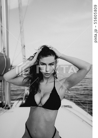 Fashion outdoor photo of beautiful young woman posing on a yachts 55605809