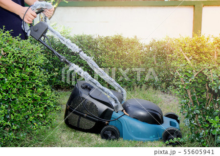Use hands to push mower to cut the grass  55605941