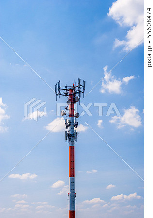 Thick red and white antenna on blue sky. Thick red and white antenna on blue sky. 55608474