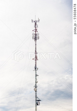 Tall red and white antenna on cloudy sky. Tall red and white antenna on cloudy sky. 55608478