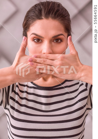 Woman trying not to tell something to others 55664591