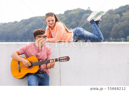 Guitarist and his muse. 55668212