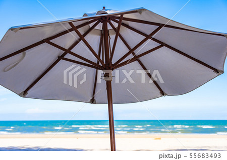 Beautiful outdoor tropical nature with white umbrella around beach and sea on blue sky Beautiful outdoor tropical nature with white umbrella around beach and sea on blue sky 55683493