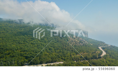 Majestic view of Triglav mountains in the clouds. Captured from Mangart mountain, located etween Majestic view of Triglav mountains in the clouds. Captured from Mangart mountain, located etween 55696060