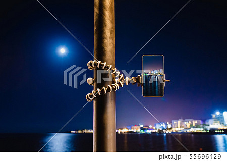 Using smartphone on flexible tripod to making the photo of sea night landscape 55696429
