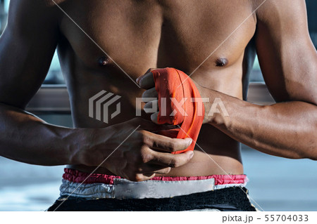 Fighter tying tape before the fight, Thai boxing Fighter tying tape before the fight, Thai boxing 55704033