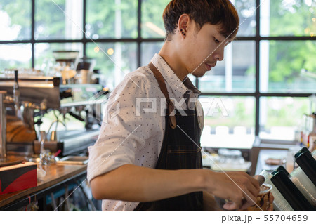 Asian barista at work during making coffee, Asian barista at work during making coffee, 55704659
