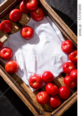Tomatoes in a wooden box. T-shirt. 55705890