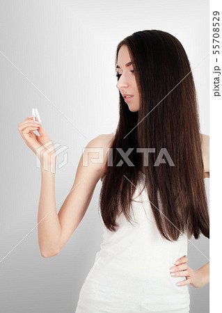 Composite image of smiling woman snapping cigarette in half Composite image of smiling woman snapping cigarette in half 55708529