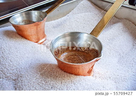 Hot tasty Coffee from copper cezve prepared on hot Hot tasty Coffee from copper cezve prepared on hot 55709427