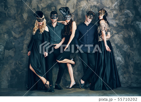 Group of people in masquerade carnival mask posing in studio Group of people in masquerade carnival mask posing in studio 55710202
