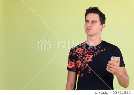 Portrait of young handsome man thinking while using phone Portrait of young handsome man thinking while using phone 55711885