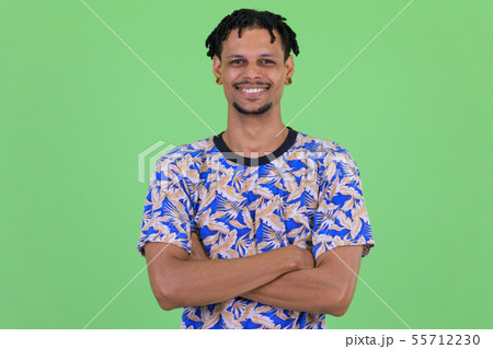 Happy young African man smiling with arms crossed Happy young African man smiling with arms crossed 55712230