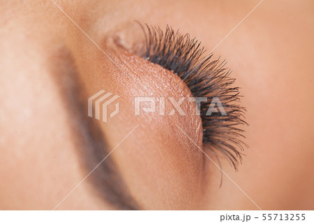 Woman Eye with Long Eyelashes. Beautiful Young Woman During Eyelash Extension 55713255