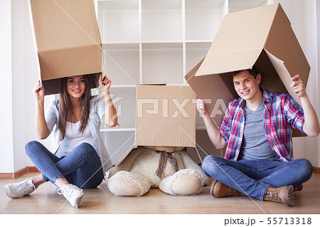 Young happy couple moving into their new home. They unpacking and cleaning new home 55713318