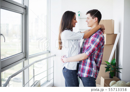 Young happy couple moving into their new home. They unpacking and cleaning new home Young happy couple moving into their new home. They unpacking and cleaning new home 55713358