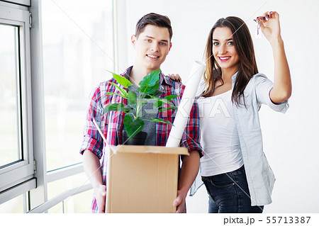 Young happy couple moving into their new home. They unpacking and cleaning new home Young happy couple moving into their new home. They unpacking and cleaning new home 55713387