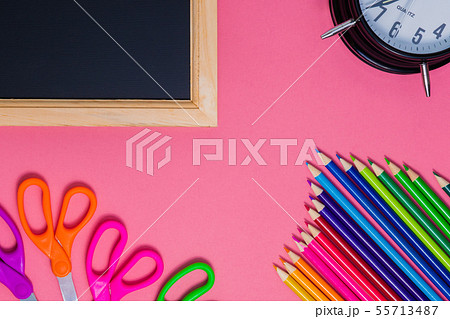 Back to school concept. Black wooden chalkboard. School supplies on pink background 55713487