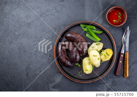 Spanish and Argentine MORCILLA blood sausages with potatoes and chile sauce Spanish and Argentine MORCILLA blood sausages with potatoes and chile sauce 55715700