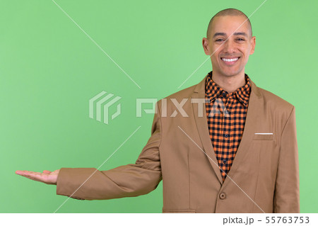 Happy bald multi ethnic businessman showing something 55763753