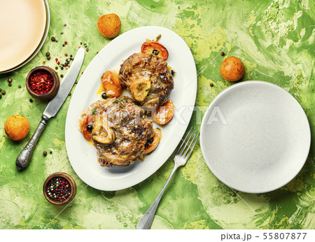 Meat cooked in apricot sauce 55807877