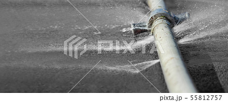 water leaking from hole in a industrial hose 55812757