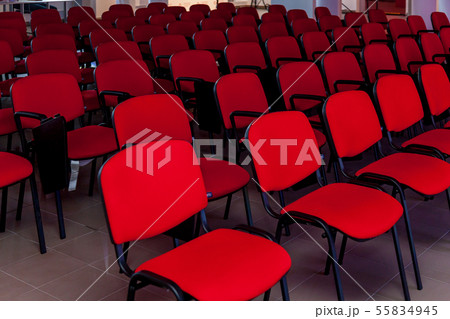Conference room with a red stage and chairs Conference room with a red stage and chairs 55834945
