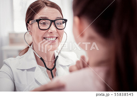 Face of a nice female doctor standing near the patient 55838545