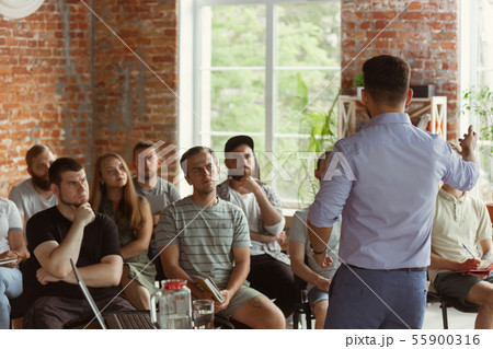 Male speaker giving presentation in hall at university workshop 55900316