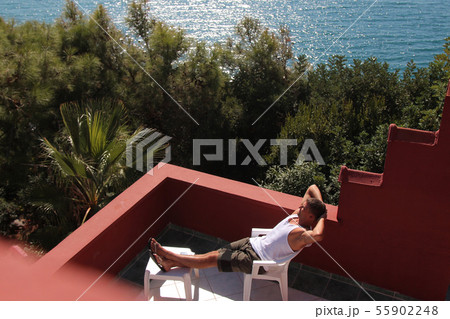 man, basking in the white dress on the balcony man, basking in the white dress on the balcony 55902248