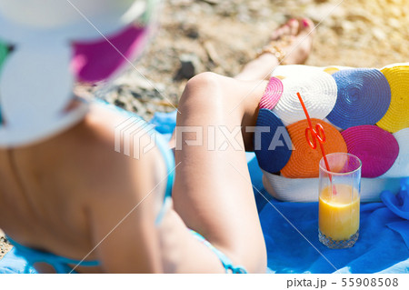 Girl resting sitting on a towel on the beach. 55908508
