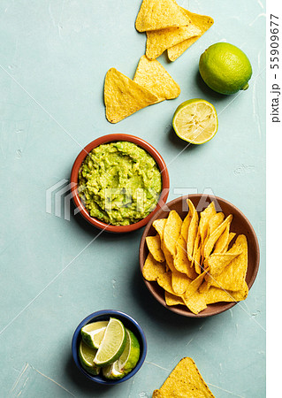 Nachos and fresh homemade guacamole on blue background 55909677