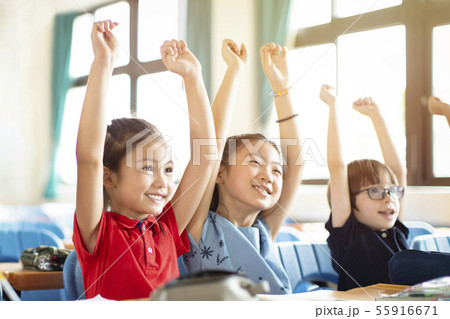 Smiling elementary school kids in classroom Smiling elementary school kids in classroom 55916671