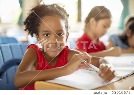 Smiling elementary school kids in classroom Smiling elementary school kids in classroom 55916675