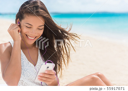 Happy smartphone woman listening streaming music 55917071