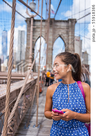 Smartphone woman on Brooklyn bridge New York 55918366