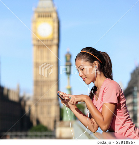 London running girl listening to smartphone music London running girl listening to smartphone music 55918867