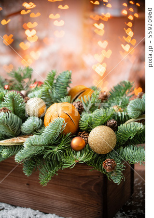 Christmas mood. Beautiful festive arrangement of fresh spruce in a rustic wooden box. Bokeh hearts 55920960