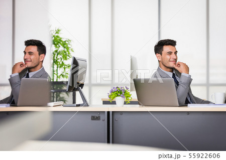 Businessman support the chin in modern office.. Businessman support the chin in modern office.. 55922606